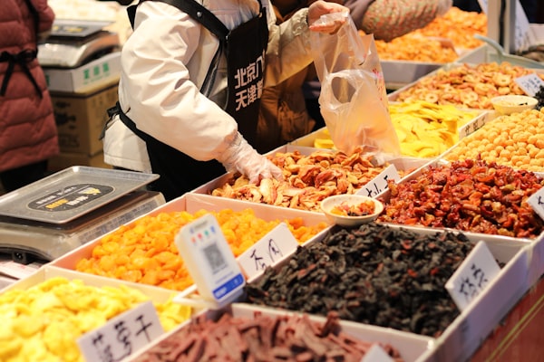 Assorted dried fruits including apricots, dates, and figs at a market